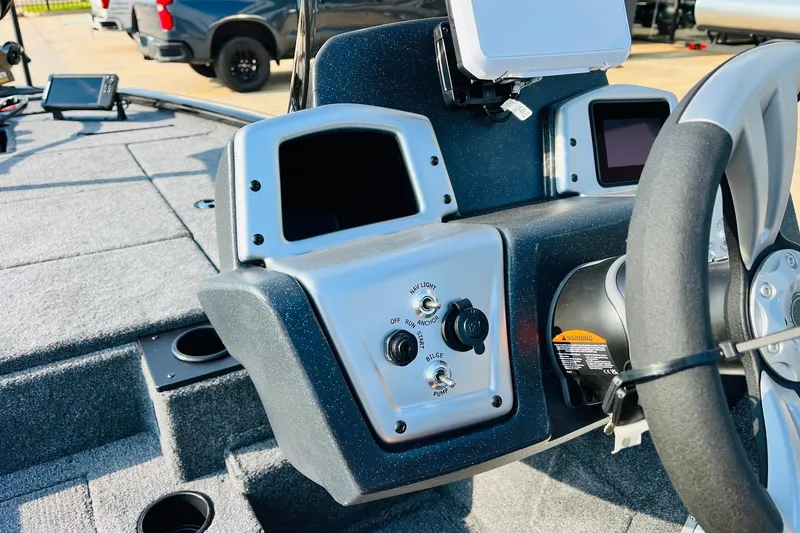 Slide: The Image of 2026 Tracker Pro Team 195 boat dashboard with steering wheel and control panel. - 32
