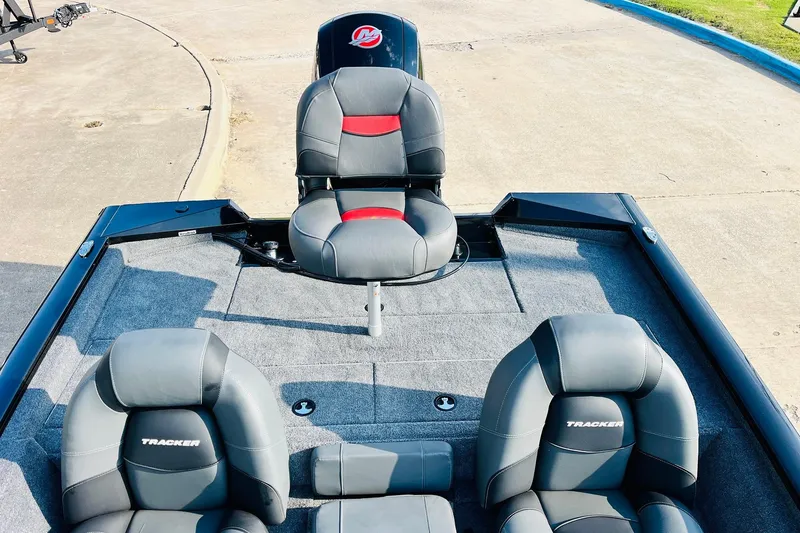 Slide: The Image of 2026 Tracker Pro Team 195 boat interior with gray and red seating. - 34