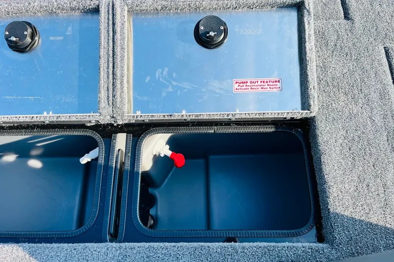 Slide: The Image of 2026 Tracker Pro Team 195 livewell compartments with pump-out feature and recirculator nozzle. - 38