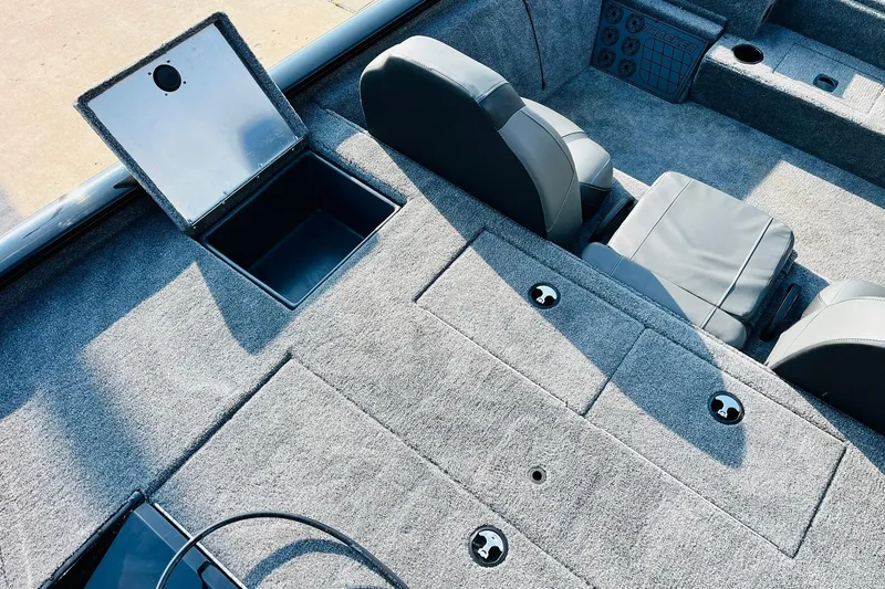 Slide: The Image of 2026 Tracker Pro Team 195 boat interior with open storage compartment and cushioned seats. - 40