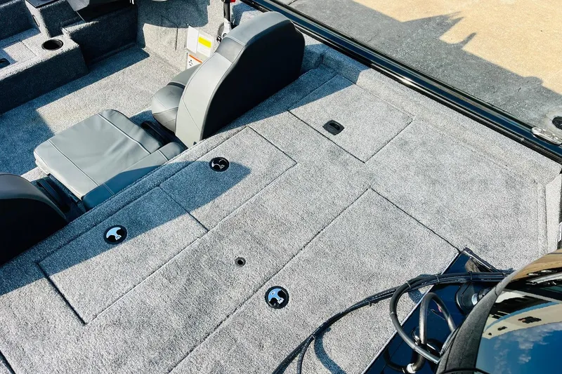 Slide: The Image of 2026 Tracker Pro Team 195 boat interior with gray seating and carpeted deck. - 42