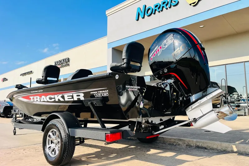 Slide: The Image of 2026 Tracker Pro Team 195 boat with powerful outboard motor, displayed at dealership. - 7