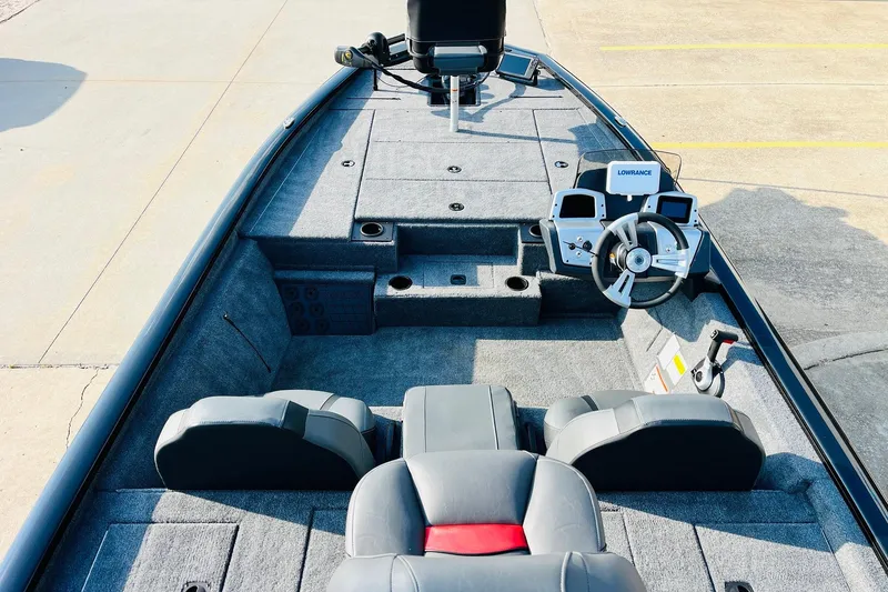 Slide: The Image of 2026 Tracker Pro Team 195 boat interior with steering wheel and seating. - 8