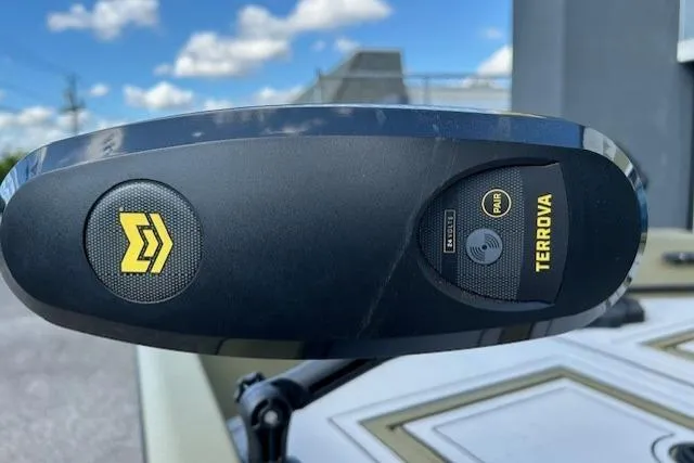 Slide: The Image of 2024 Lund 1660 Predator Tiller boat with Terrova trolling motor, under a clear blue sky. - 16