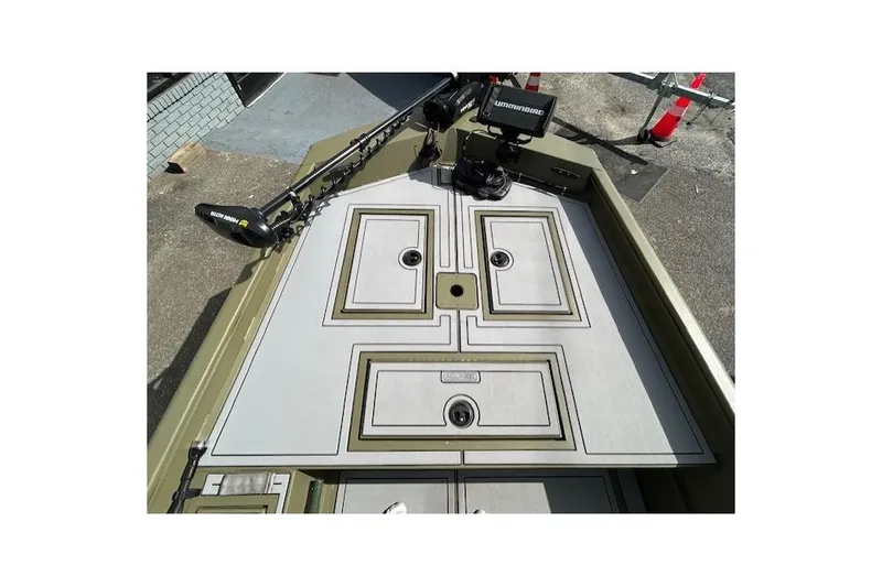 Slide: The Image of 2024 Lund 1660 Predator Tiller boat deck with storage compartments and trolling motor. - 8