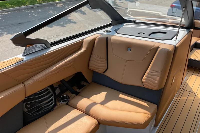 Slide: The Image of 2026 Nautique Super Air Nautique G23 interior with tan leather seating and modern design. - 10