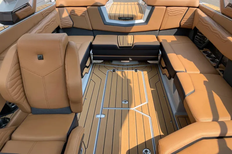 Slide: The Image of Luxurious interior of 2026 Nautique Super Air Nautique G23 boat with tan leather seating. - 12