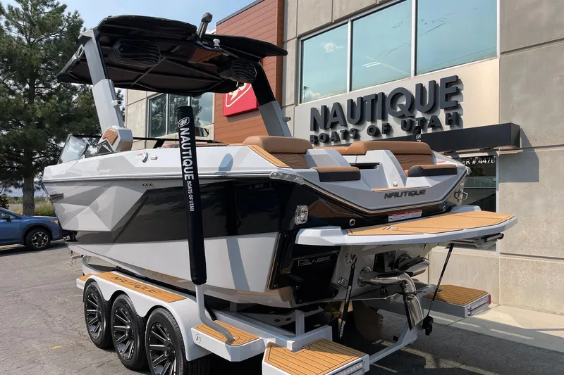 Slide: The Image of 2026 Nautique Super Air Nautique G23 boat displayed at dealership, rear view. - 3