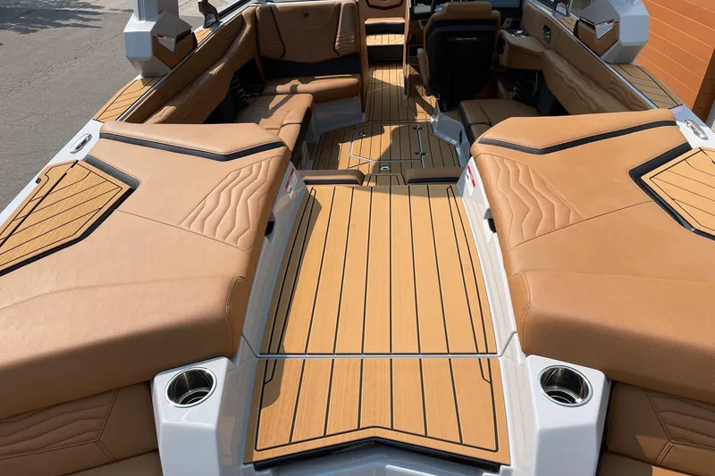 Slide: The Image of 2026 Nautique Super Air Nautique G23 interior with tan upholstery and sleek design. - 4