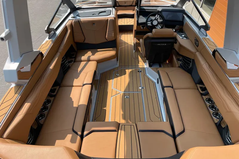 Slide: The Image of 2026 Nautique Super Air Nautique G23 interior with luxurious tan seating and sleek design. - 5