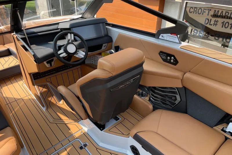 Slide: The Image of 2026 Nautique Super Air Nautique G23 interior with tan upholstery and modern dashboard design. - 6
