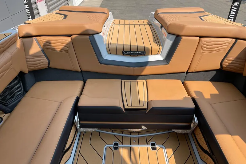 Slide: The Image of 2026 Nautique Super Air Nautique G23 interior with tan leather seating and stylish design. - 8