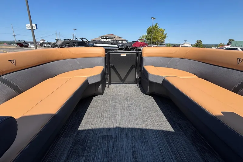 Slide: The Image of Interior of 2026 Viaggio Z24U boat with tan and gray seating, outdoor setting. - 25