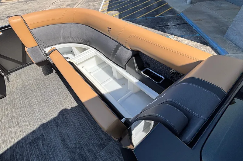 Slide: The Image of 2026 Viaggio Z24U boat interior with tan and gray seating, open storage compartment. - 28