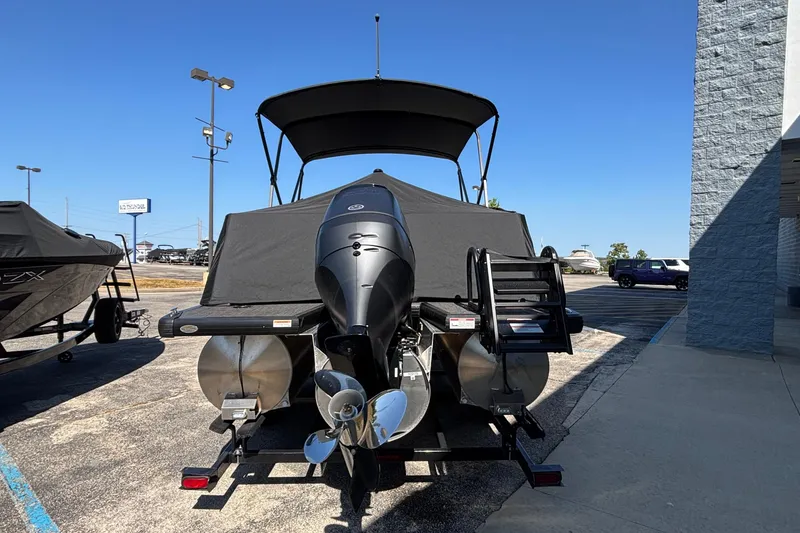 Slide: The Image of 2026 Viaggio Z24U pontoon boat with outboard motor, parked outdoors under clear blue sky. - 41