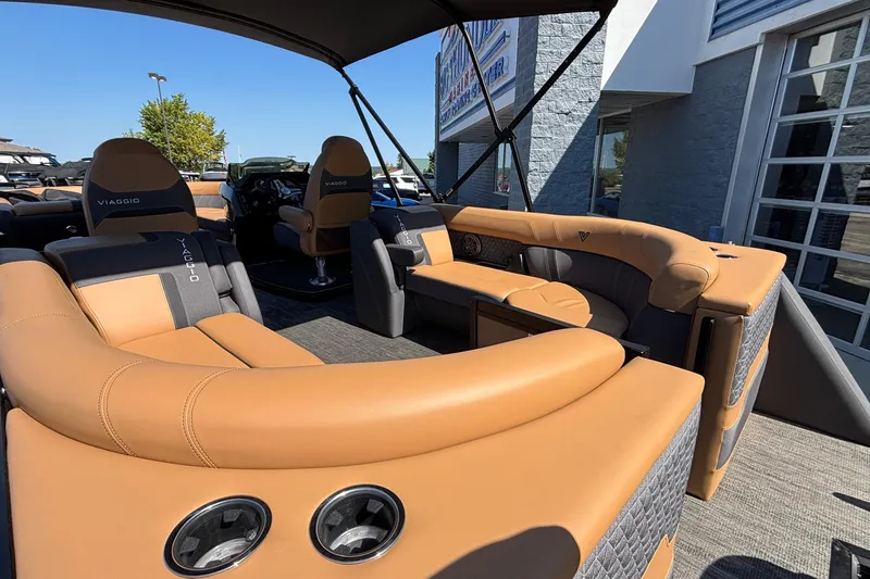 Slide: The Image of 2026 Viaggio Z24U boat interior with tan and gray seating, under a canopy. - 8