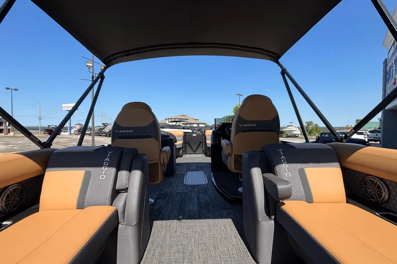 Slide: The Image of 2026 Viaggio Z24U boat interior with tan and gray seating under a canopy. - 9