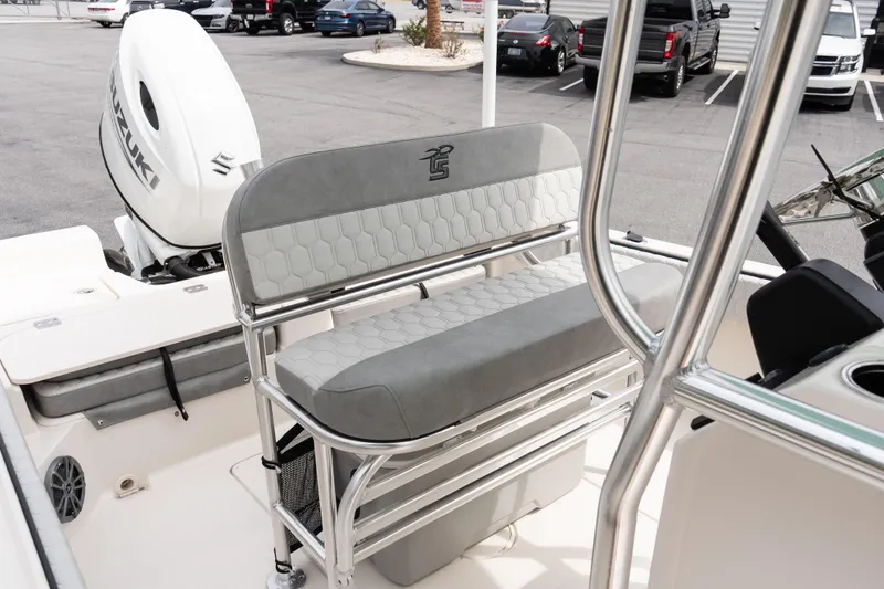 Slide: The Image of 2026 Carolina Skiff 21 Ultra Elite boat interior with Suzuki engine in parking lot. - 11