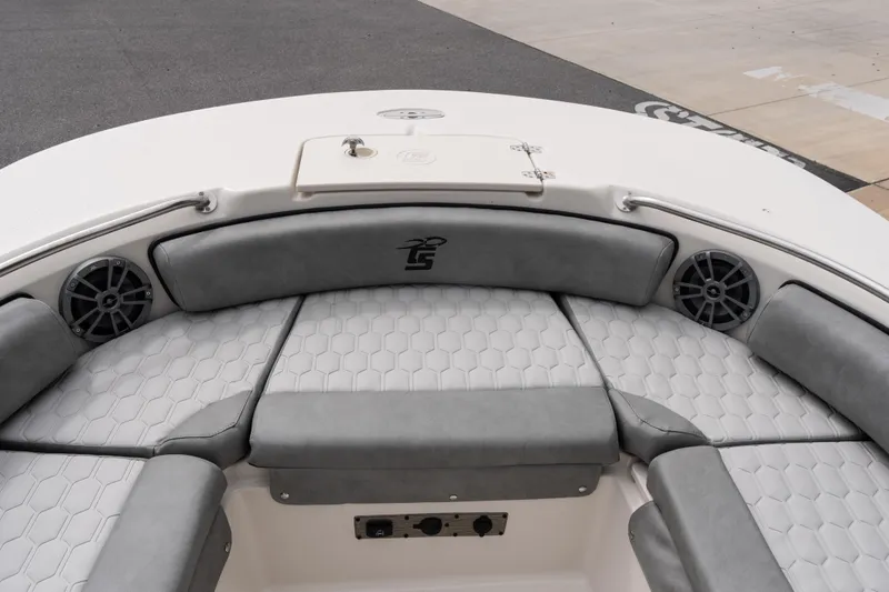 Slide: The Image of 2026 Carolina Skiff 21 Ultra Elite boat interior with gray cushioned seating and speakers. - 15