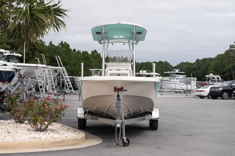 Slide: The Image of 2026 Carolina Skiff 21 Ultra Elite boat on trailer in a dealership lot. - 3
