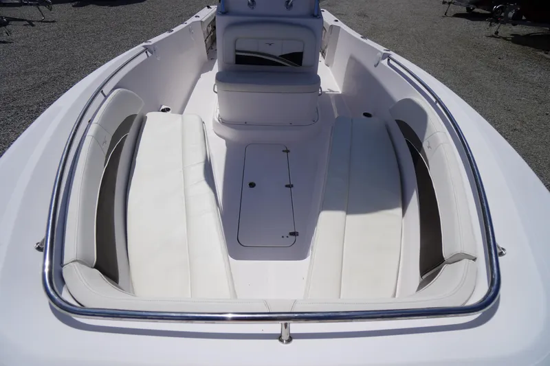 Slide: The Image of 2016 Pro-Line 29 Grand Sport boat interior with white seating and storage compartments. - 11