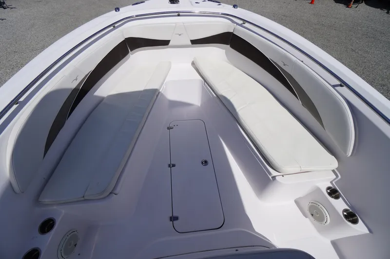 Slide: The Image of 2016 Pro-Line 29 Grand Sport boat interior with white seating and storage compartments. - 12