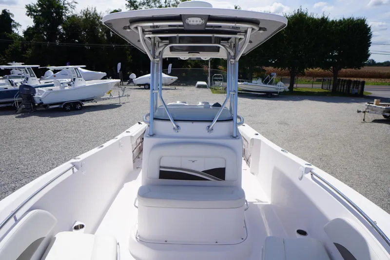 Slide: The Image of 2016 Pro-Line 29 Grand Sport boat with T-top, parked on gravel lot. - 19