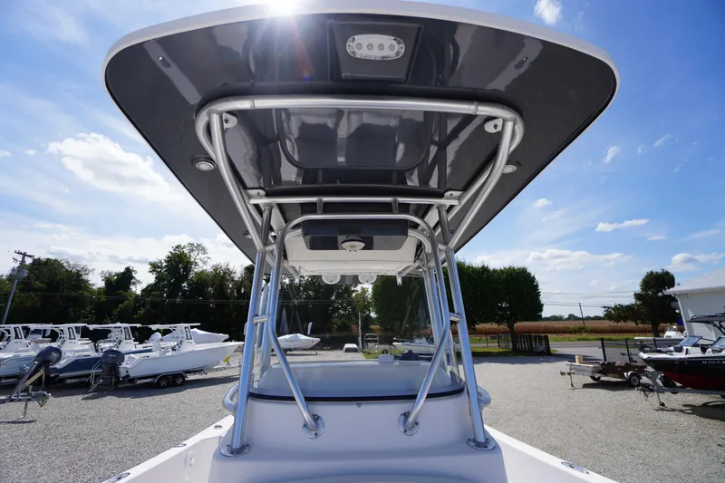 Slide: The Image of 2016 Pro-Line 29 Grand Sport boat with T-top, parked outdoors under a clear sky. - 20