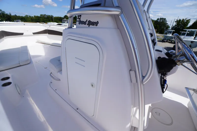 Slide: The Image of 2016 Pro-Line 29 Grand Sport boat interior with seating and steering console. - 22