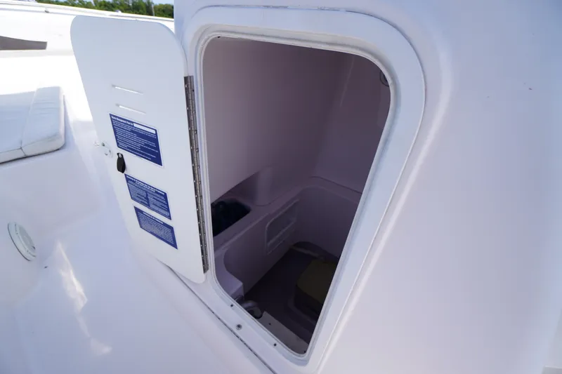 Slide: The Image of Open storage compartment on 2016 Pro-Line 29 Grand Sport boat. - 23