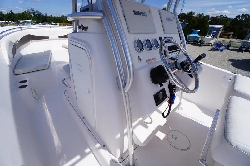 Slide: The Image of 2016 Pro-Line 29 Grand Sport boat interior with steering console and seating. - 25
