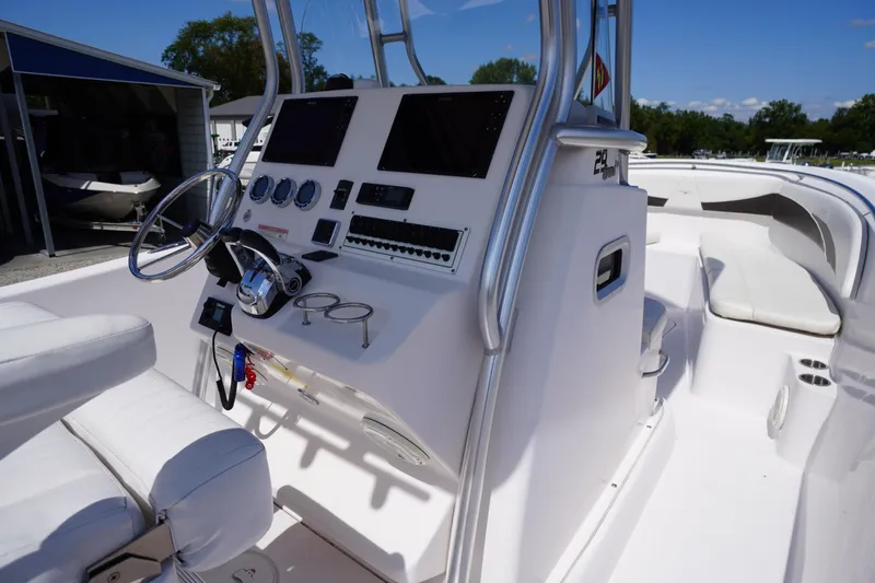 Slide: The Image of 2016 Pro-Line 29 Grand Sport boat interior with steering console and seating. - 29