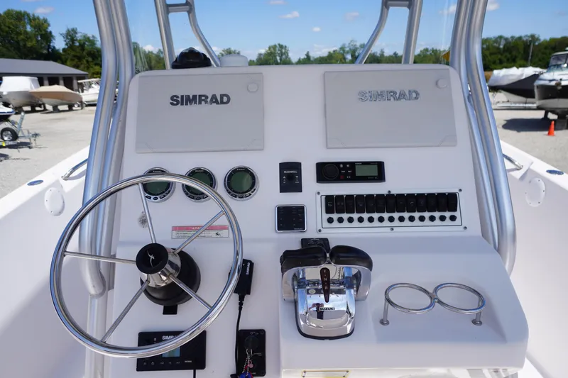 Slide: The Image of 2016 Pro-Line 29 Grand Sport boat dashboard with steering wheel and Simrad electronics. - 30