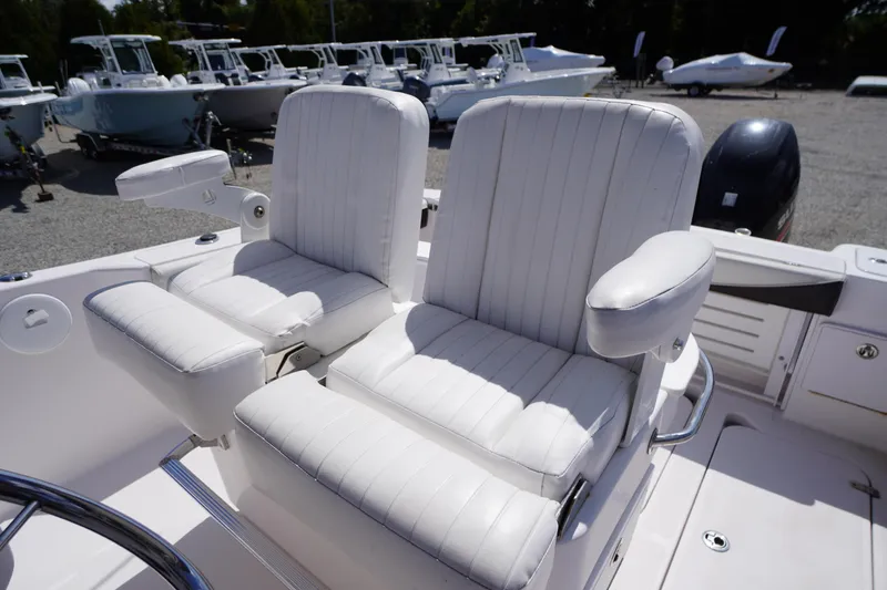 Slide: The Image of 2016 Pro-Line 29 Grand Sport boat with white cushioned seats and armrests. - 34