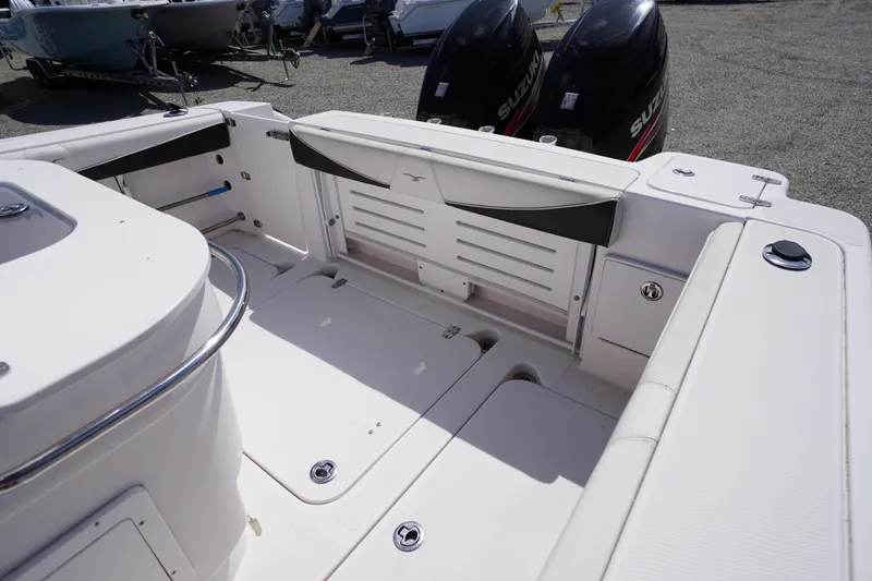 Slide: The Image of 2016 Pro-Line 29 Grand Sport boat interior with dual Suzuki outboard motors. - 40