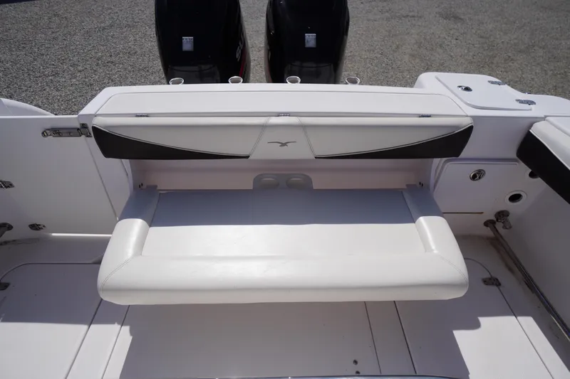 Slide: The Image of 2016 Pro-Line 29 Grand Sport boat with white seating and dual outboard motors. - 42