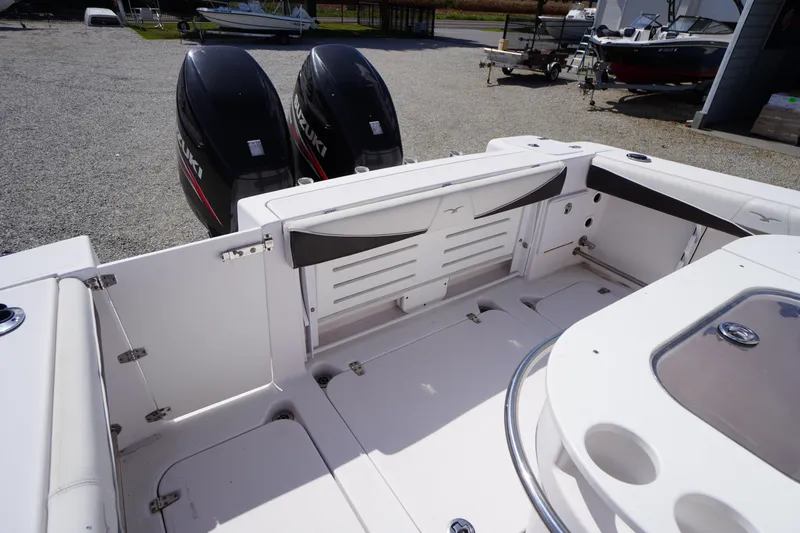 Slide: The Image of 2016 Pro-Line 29 Grand Sport boat interior with dual Suzuki outboard motors. - 44