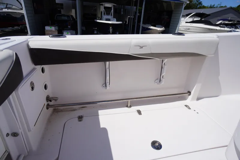 Slide: The Image of 2016 Pro-Line 29 Grand Sport boat interior, featuring white seating and stainless steel fixtures. - 45
