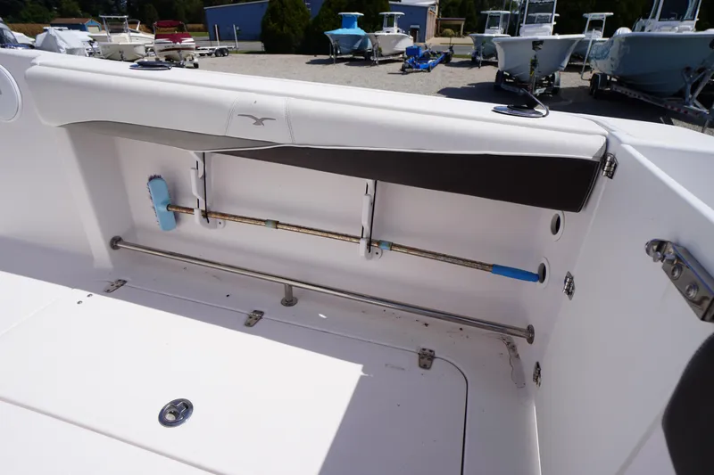Slide: The Image of 2016 Pro-Line 29 Grand Sport boat interior with storage compartment and rod holders. - 46