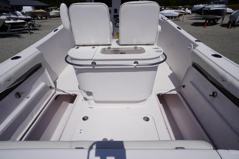 Slide: The Image of 2016 Pro-Line 29 Grand Sport boat interior with seating and storage compartments. - 48