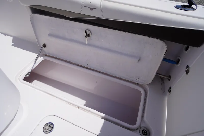Slide: The Image of Open storage compartment on 2016 Pro-Line 29 Grand Sport boat. - 49