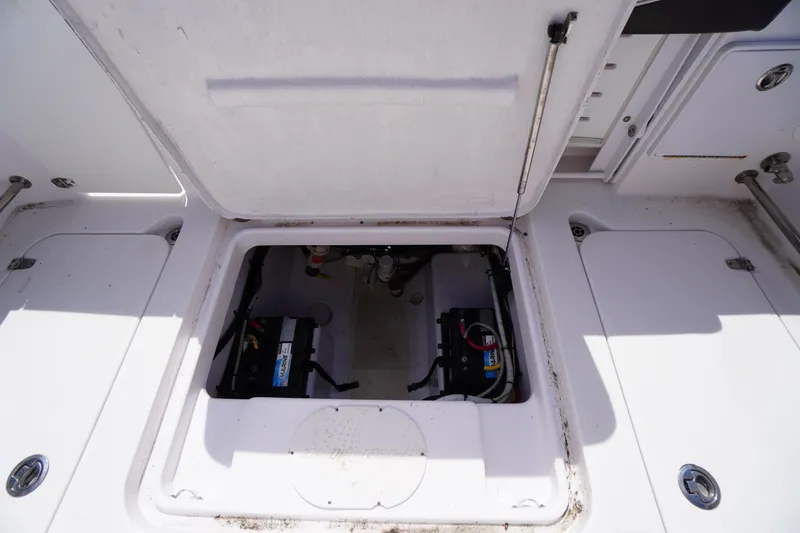 Slide: The Image of 2016 Pro-Line 29 Grand Sport boat battery compartment with open hatch. - 53
