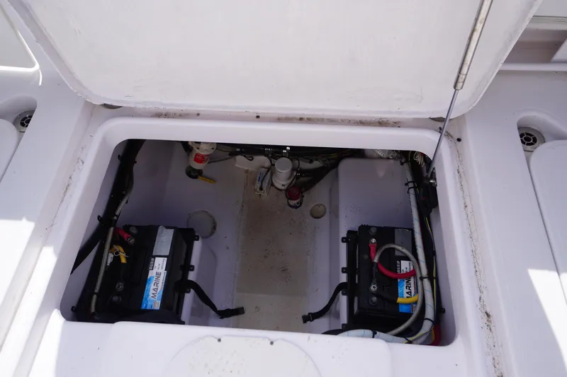 Slide: The Image of 2016 Pro-Line 29 Grand Sport boat battery compartment with dual marine batteries. - 54