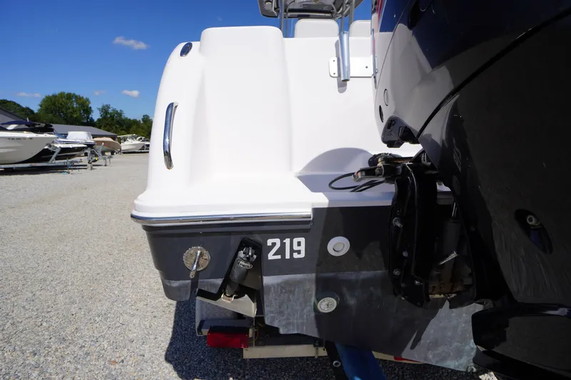 Slide: The Image of 2016 Pro-Line 29 Grand Sport boat rear view with outboard motor in a marina. - 60