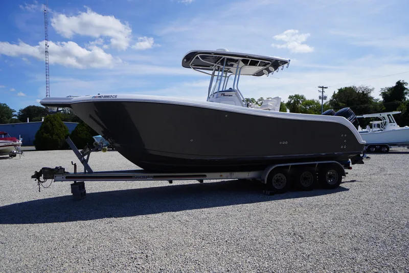 Slide: The Image of 2016 Pro-Line 29 Grand Sport boat on trailer under clear blue sky. - 65