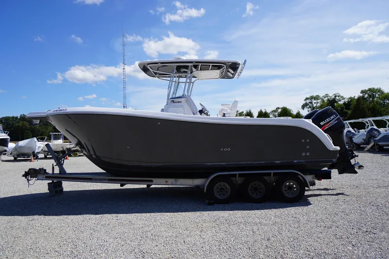 Slide: The Image of 2016 Pro-Line 29 Grand Sport boat on trailer under clear blue sky. - 66