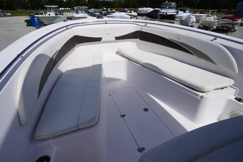 Slide: The Image of 2016 Pro-Line 29 Grand Sport boat interior with cushioned seating and storage compartments. - 8