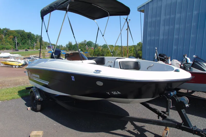 The Image of 2016 Bayliner 160 Element boat with canopy on trailer, parked outdoors. - 1