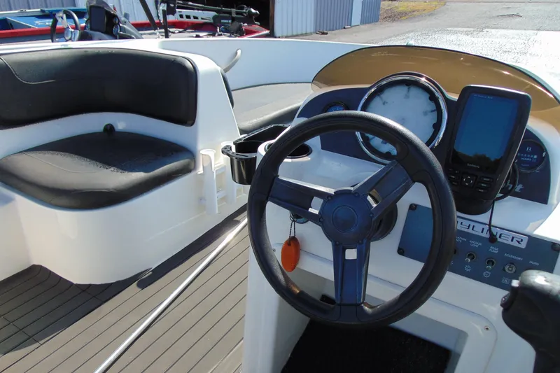 Slide: The Image of 2016 Bayliner 160 Element boat interior with steering wheel and dashboard controls. - 10