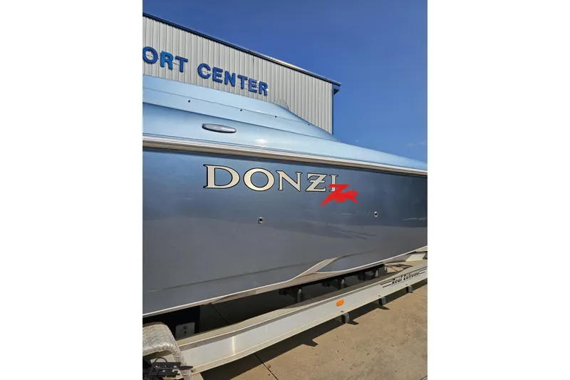 Slide: The Image of 2007 Donzi 35 ZR boat in blue, displayed at a marine center. - 10